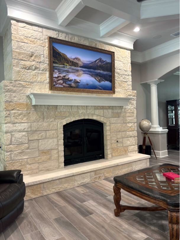 Living room fireplace with framed TV display