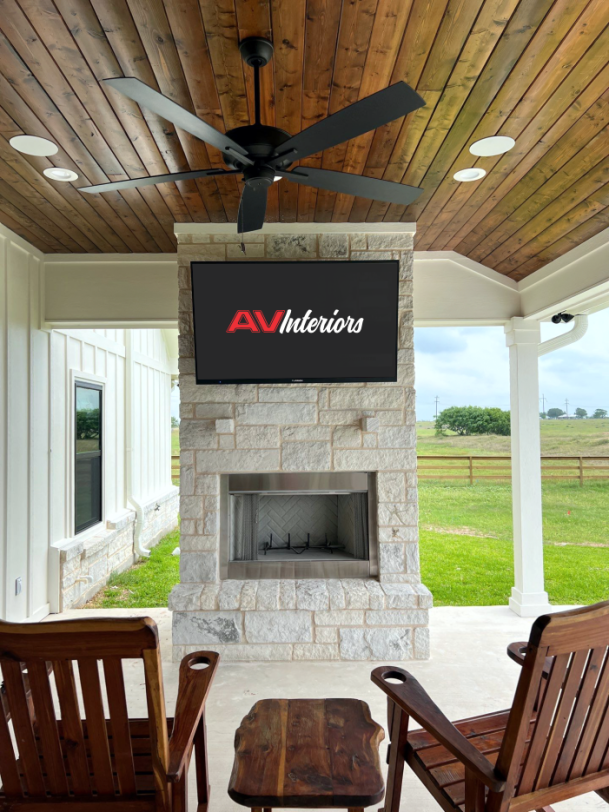 Outdoor patio with AV Interiors TV above fireplace