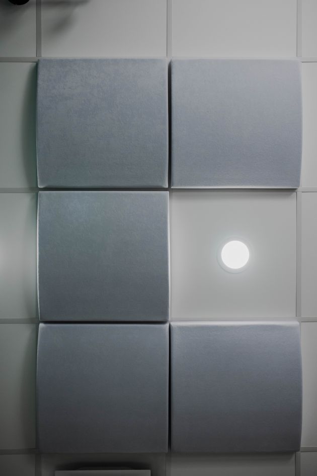 Gray acoustic wall panels with spotlight