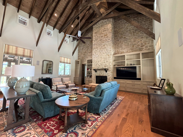 Rustic living room with stone fireplace and wood beams