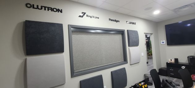Wall display with Lutron and Paradigm logos