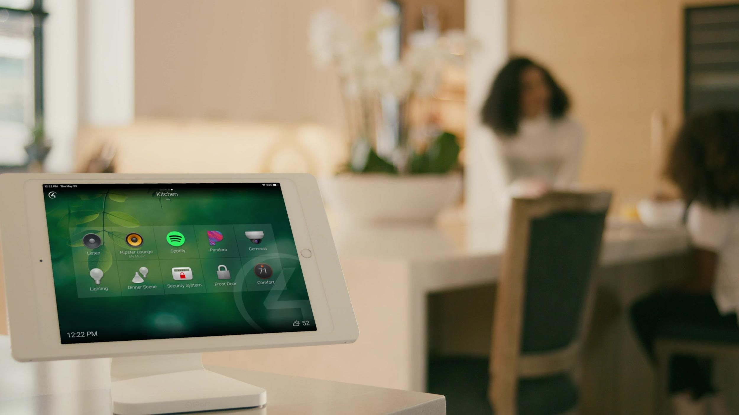 Control4 Touch panel in a able with a traditional home in the background