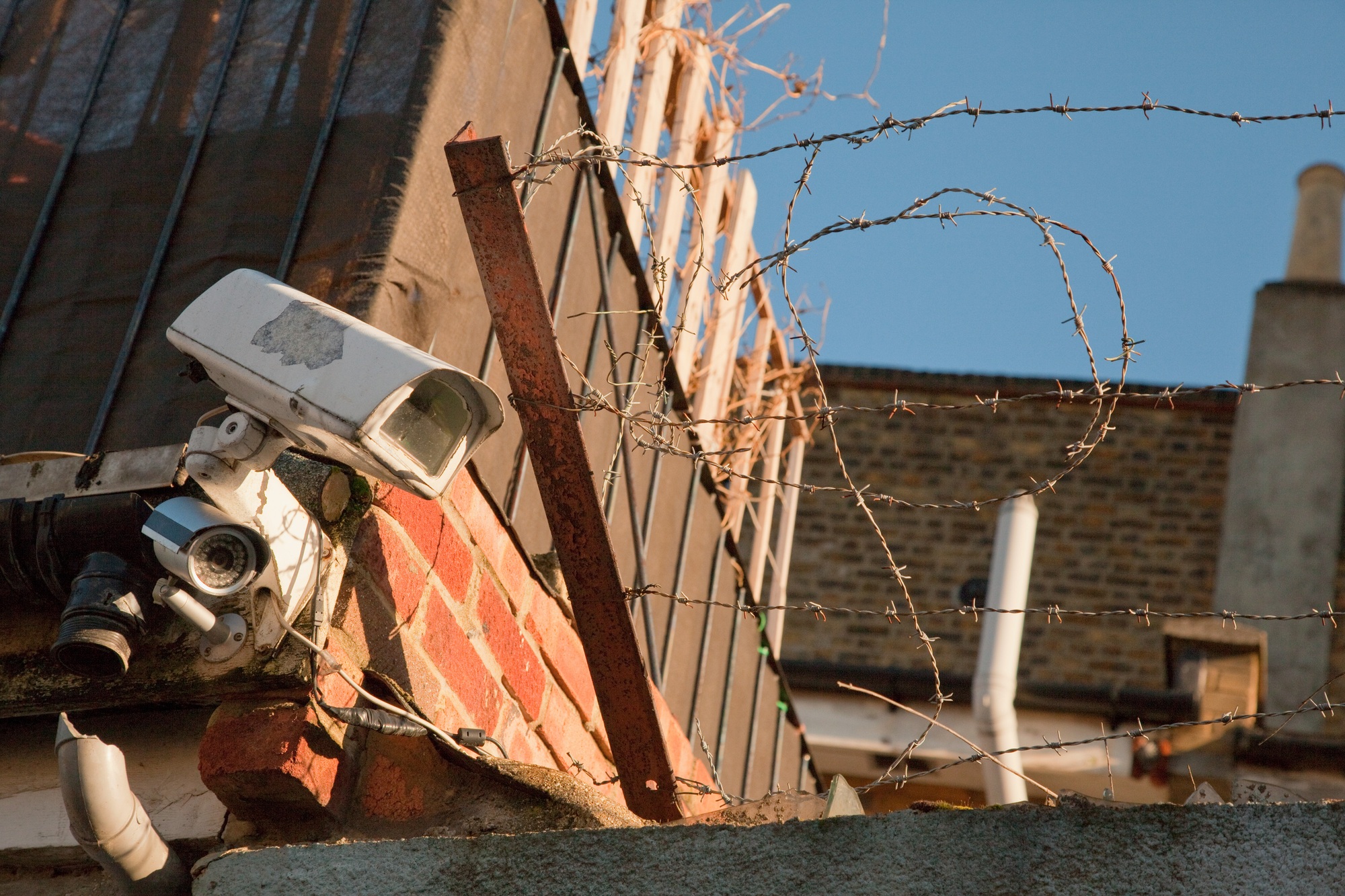Surveillance camera and barbed wire